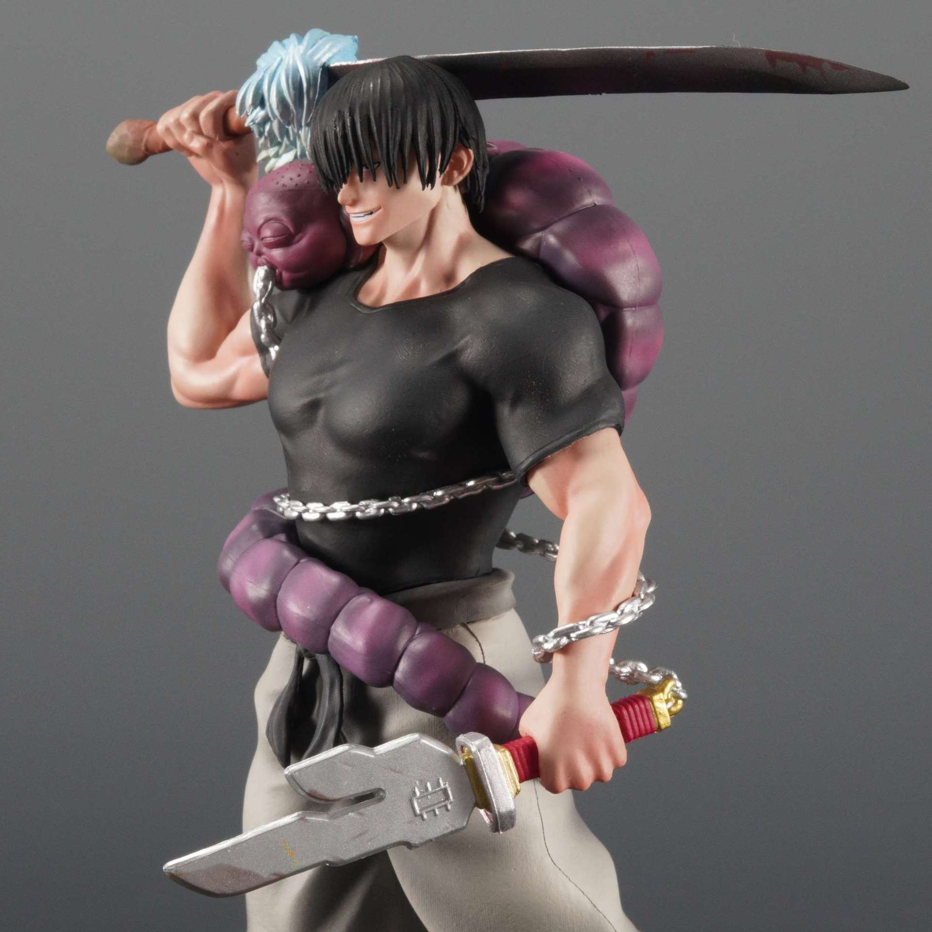 The Jujutsu Kaisen Fushiguro Toji PVC Figure is a 21 cm statue featuring a mysterious male character with black hair covering his eyes, wielding a large sword. He wears a black shirt and light pants, entangled with a purple snake-like shikigami, making it the perfect collectible for fans.