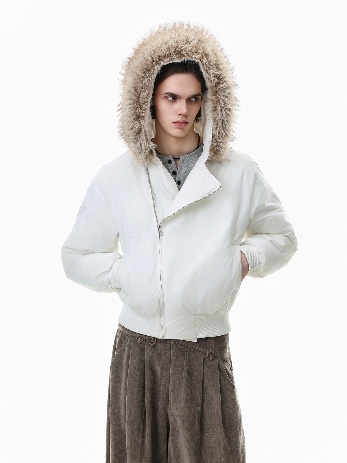 Cropped white puffer bomber jacket with large faux-fur trimmed hood and asymmetric diagonal zip closure, styled with wide-leg
