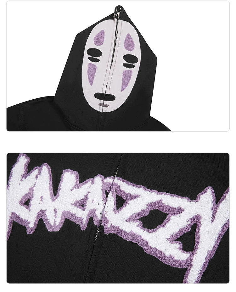 The Spirited Away No-Face Anime Hoodie is a black zip-up sweatshirt for anime fans, featuring a white No-Face mask with purple and black details on the hood. &quot;KAKAZZY&quot; is boldly displayed in textured purple and white lettering below.