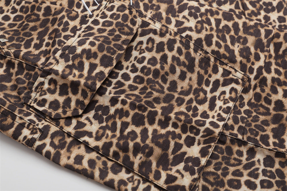 Close-up of leopard print cargo shorts side flap pocket with stitched panel details