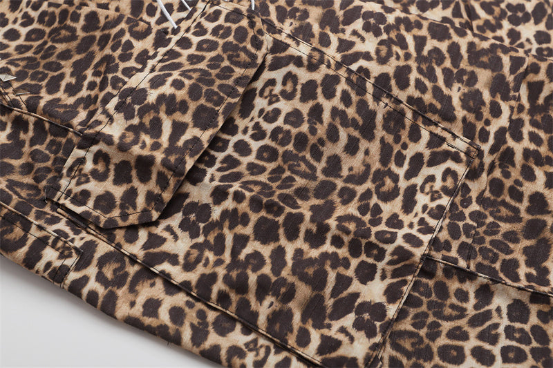 Close-up of leopard print cargo shorts side flap pocket with stitched panel details
