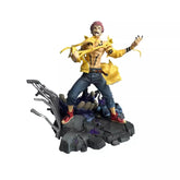 The Jujutsu Kaisen Yuji Itadori Dual Face PVC Figure is a 1/6 scale, 27 cm collectible statue featuring spiky-haired Yuji in an open yellow jacket with cursed energy effects around black flames on a rocky base and a skeletal backdrop.