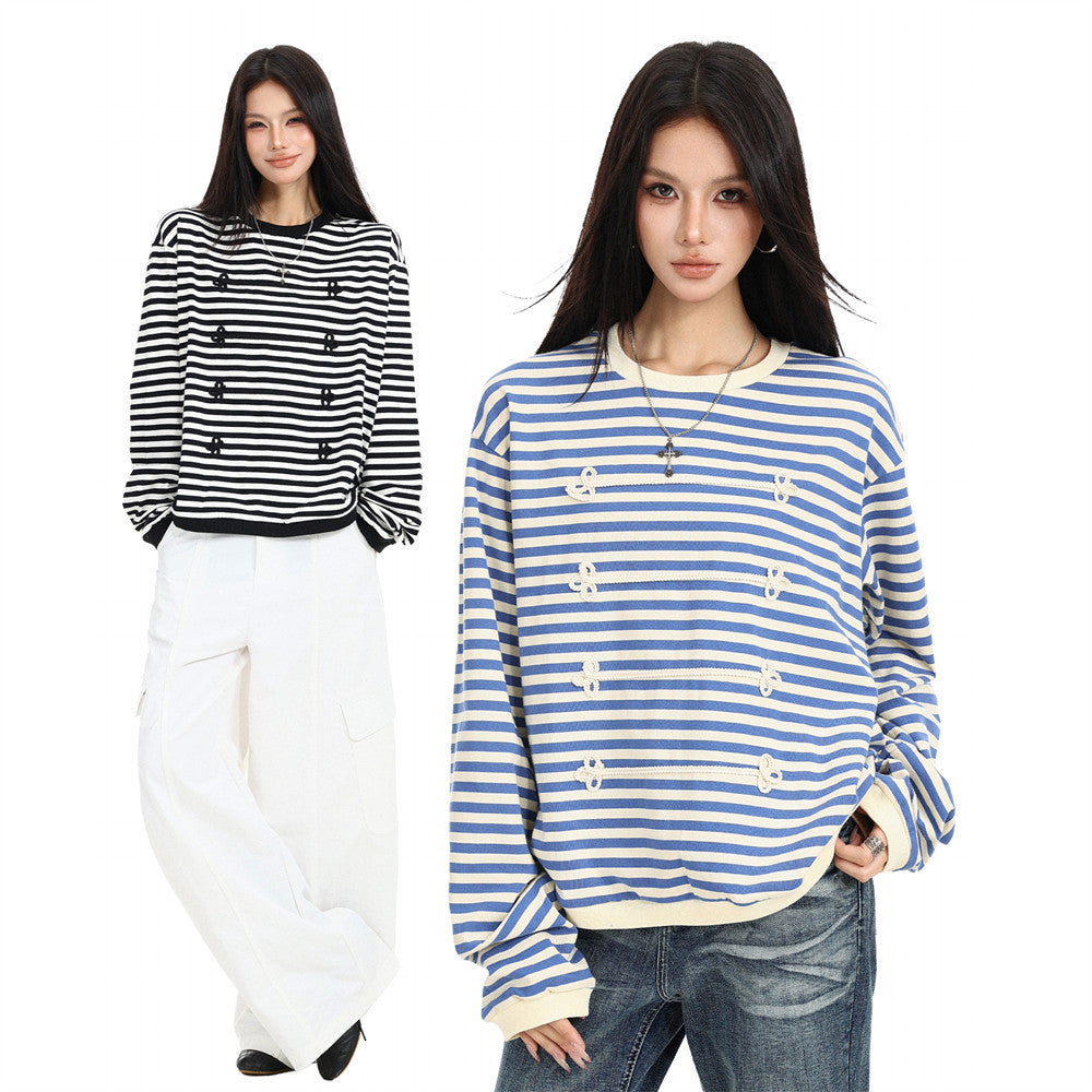 Two models wearing black and white and blue striped long sleeve shirts with contrast trim