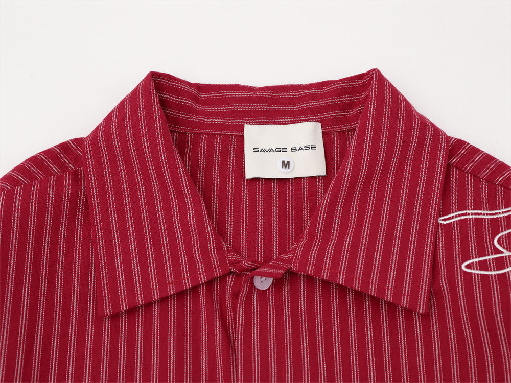 Close-up of red striped shirt collar and upper button placket with brand label