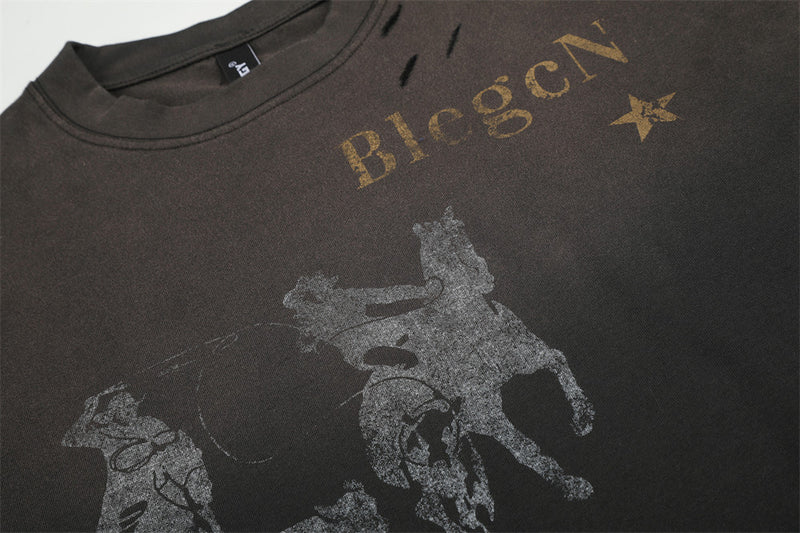 Close-up of front chest print showing faded horse graphic and gold lettering on black T-shirt