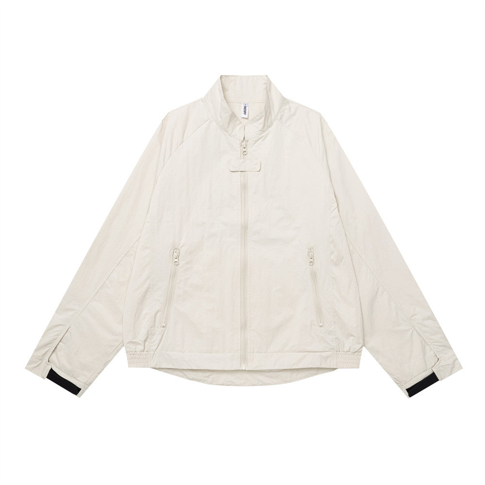 Men's oversized cream stand-collar zip-up jacket with zip pockets and contrast black cuffs, front view