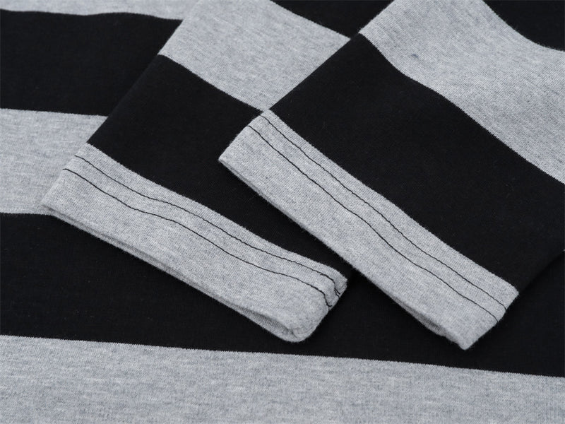 Close-up of folded sleeve cuffs on black and gray striped long sleeve shirt