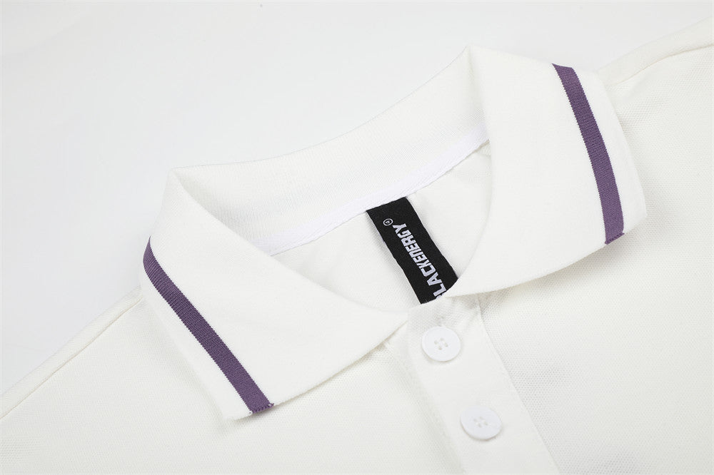 Close-up of white polo collar with purple stripe trim and button placket
