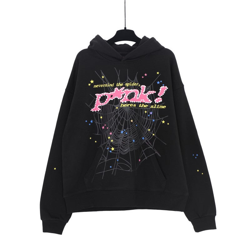 A Trendy Sp5der Hoodie from Sp5der hangs on a hanger, showcasing streetwear fashion with its eye-catching web print design, featuring colorful stars and the phrase &quot;never mind the spider punk! here&