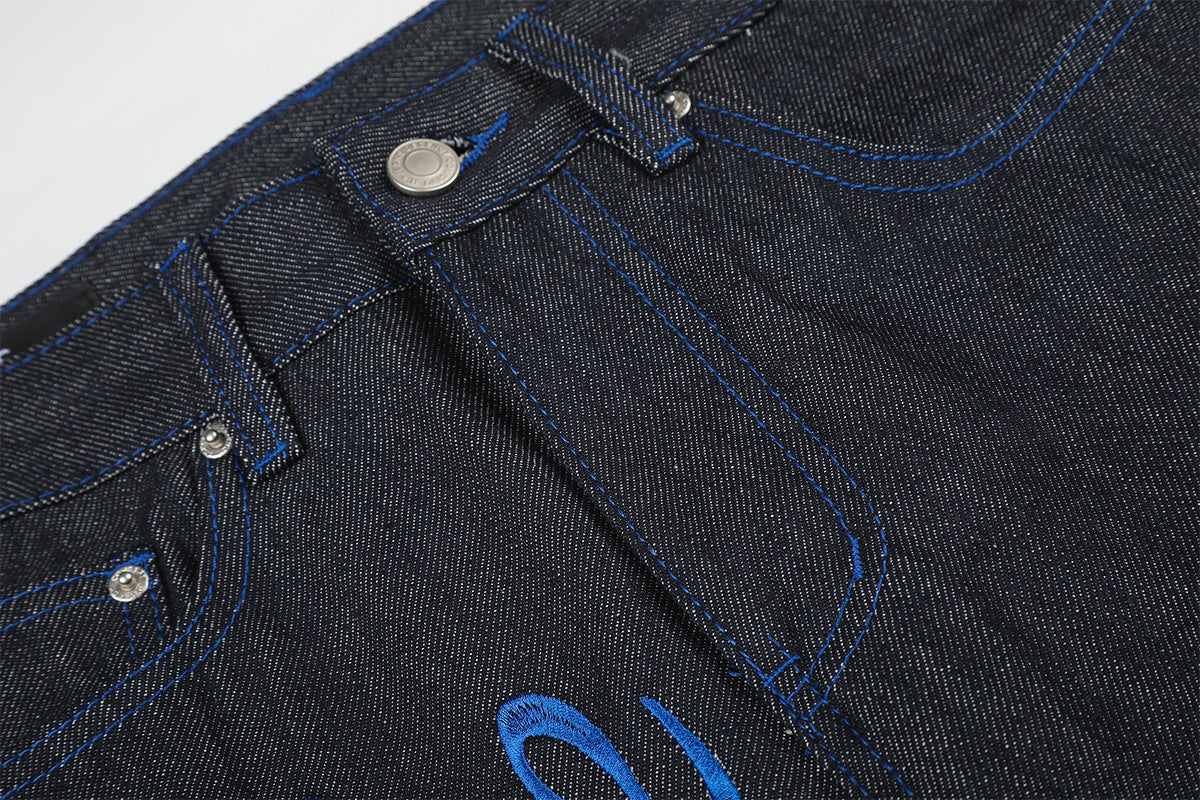 Jean baggy à jambes larges avec broderie bleue effet script et fil barbelé