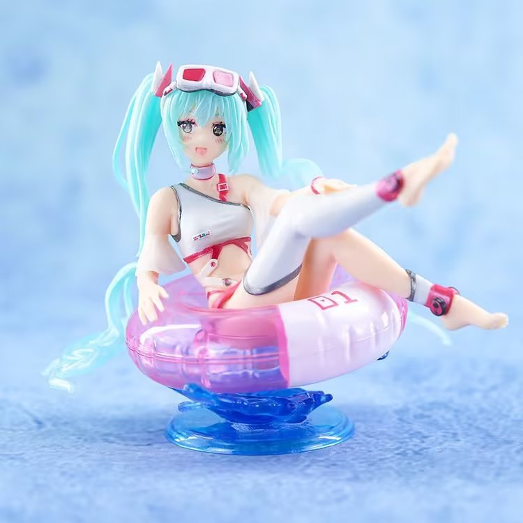 The Hatsune Miku Swimsuit with Float Ring 11cm PVC Figure features the iconic character with long turquoise hair lounging on a pink inflatable chair in a white and pink outfit, complete with pink goggles. The soft blue background enhances this whimsical summer-themed collectible.