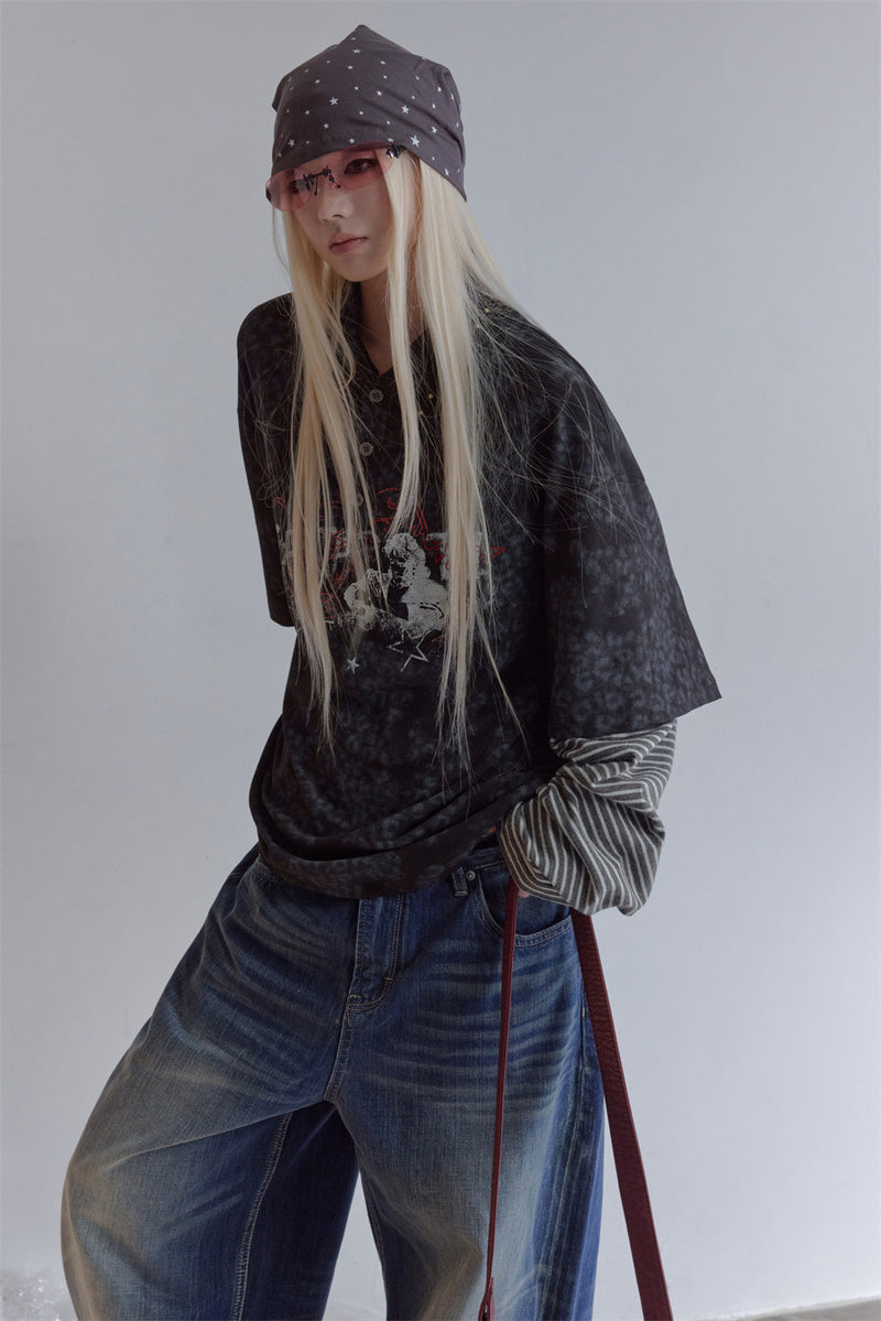 Side view of a dark patterned polo shirt worn with contrasting striped sleeves and a printed front