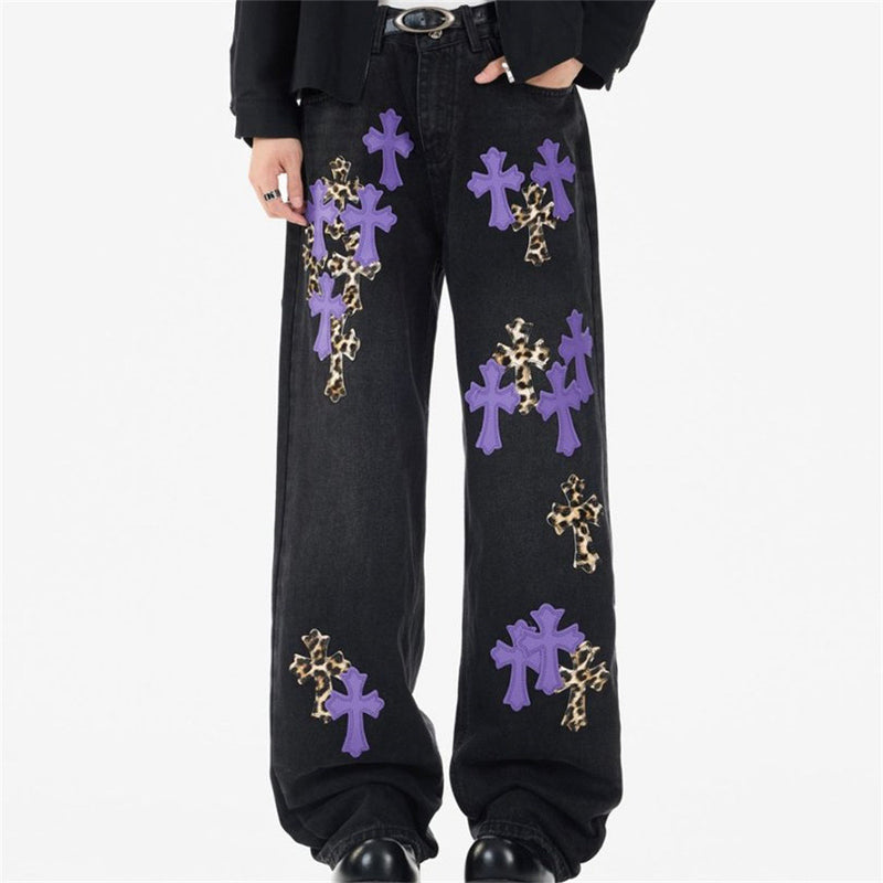 Black wide-leg jeans with purple and leopard cross patches, front view on model