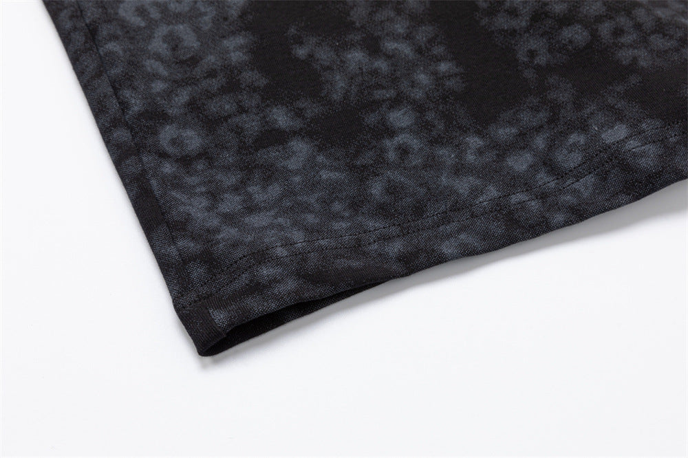 Close-up of the dark mottled shirt hem showing the folded edge and stitched finish