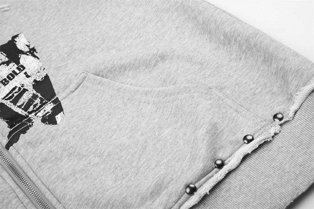 Close-up of light gray hoodie kangaroo pocket and studded hem detail