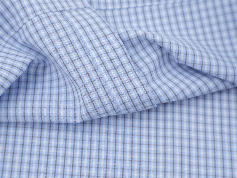 Close-up of the light blue plaid shirt sleeve with contrast piping and gathered seam