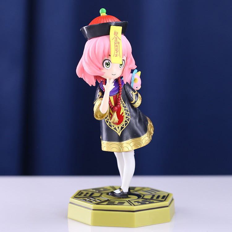 The Spy × Family Anya Forger PVC Figure depicts Anya in a school uniform and adorable pose. This 18 cm chibi-style figure features pink hair and includes a toy, set on a hexagonal base with a geometric design against a dark blue background.