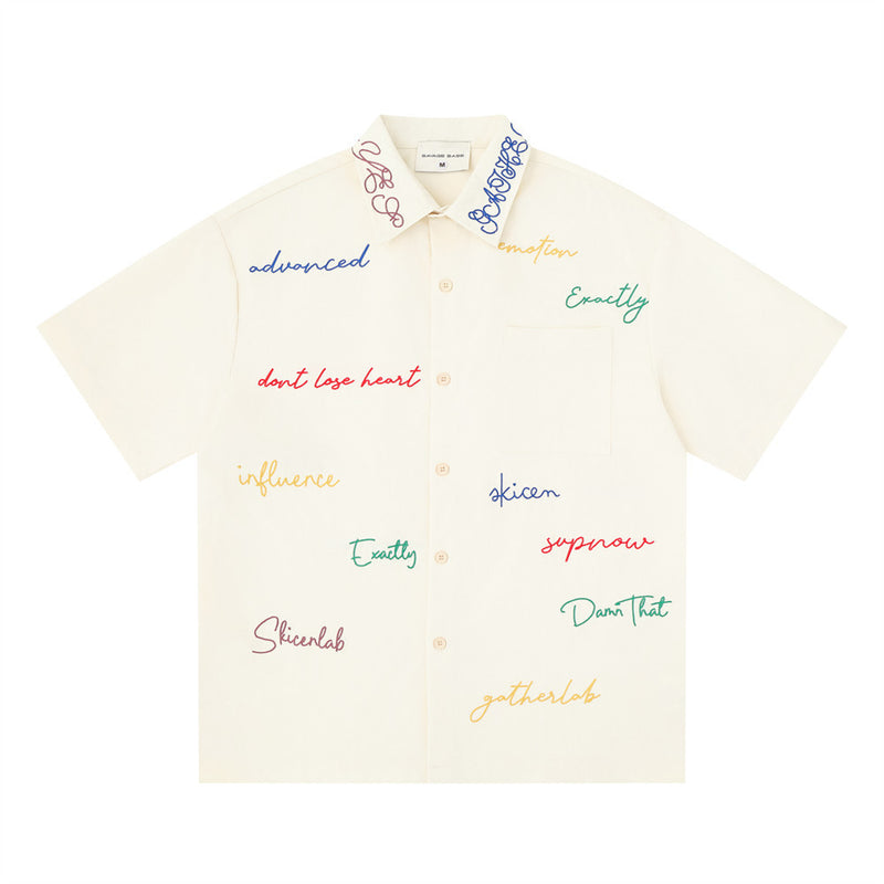 Cream short sleeve button-down shirt with multicolor graffiti script embroidery, front view