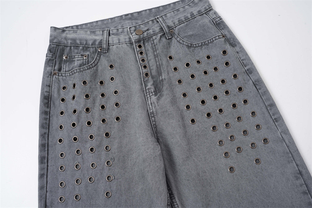 Front upper view of washed grey baggy jeans with metal eyelet panels and straight legs