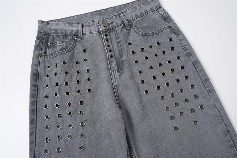 Front upper view of washed grey baggy jeans with metal eyelet panels and straight legs