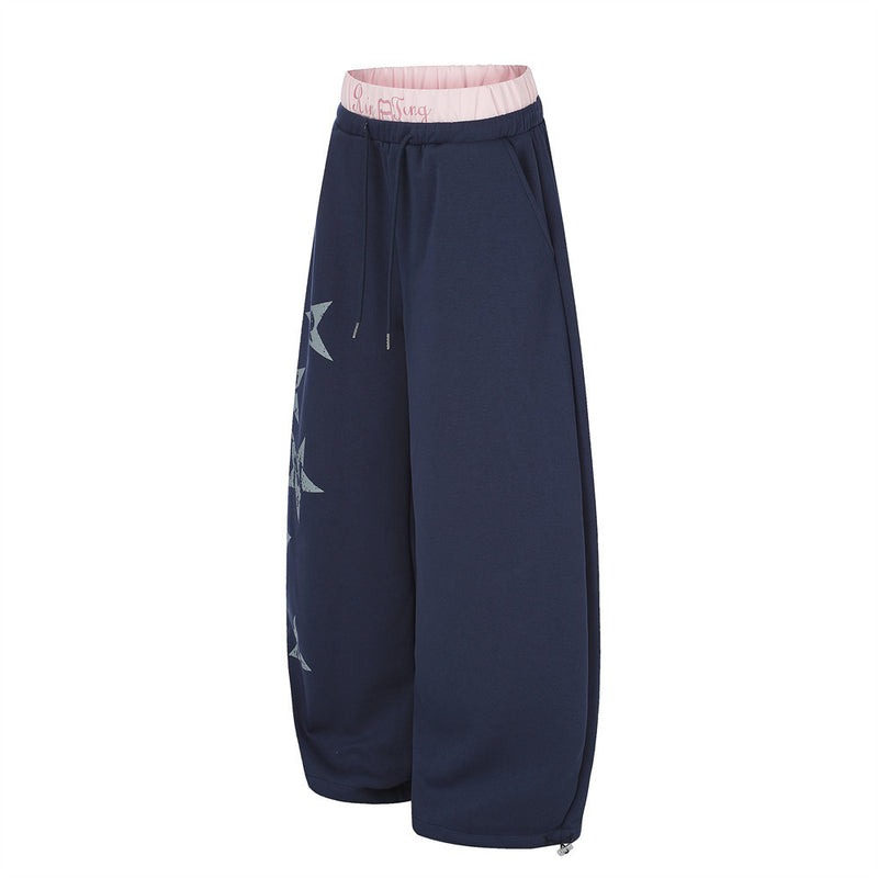 Navy wide-leg sweatpants, side view with pink double waistband and loose leg fit