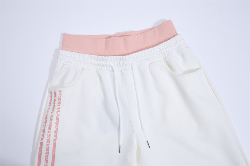 Pantalones de chándal de pierna ancha con estampado gráfico varsity y cintura rosa en contraste