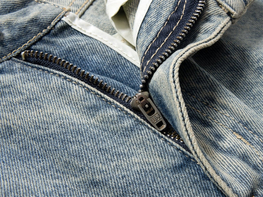 Close-up of metal zipper on light wash denim jeans