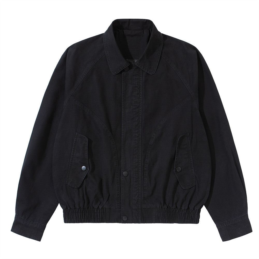 Vintage washed workwear bomber jacket in black with snap-button front, flap pockets, and elasticated hem