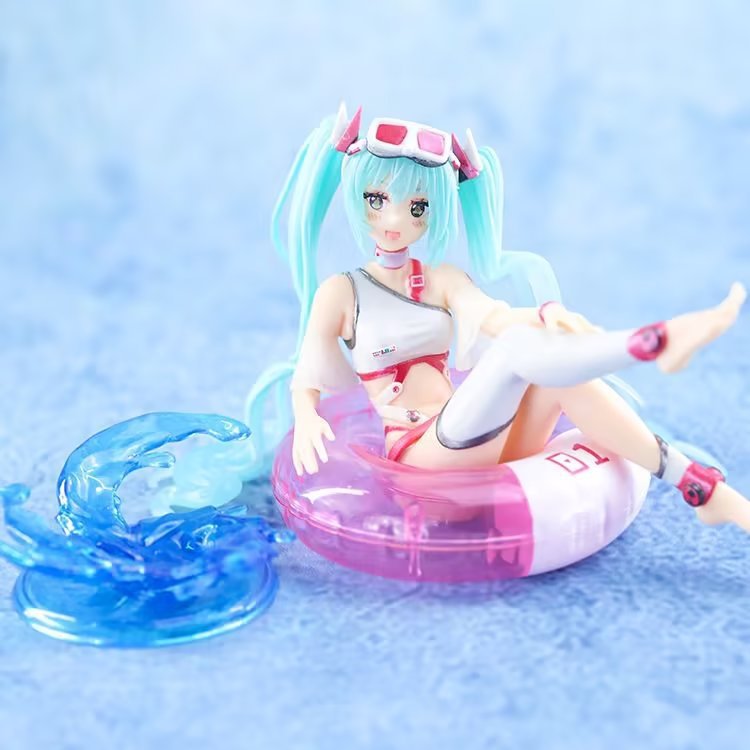 The Hatsune Miku Swimsuit with Float Ring 11cm PVC Figure features Miku with long teal hair and pink goggles on a pink and white inflatable ring. She&