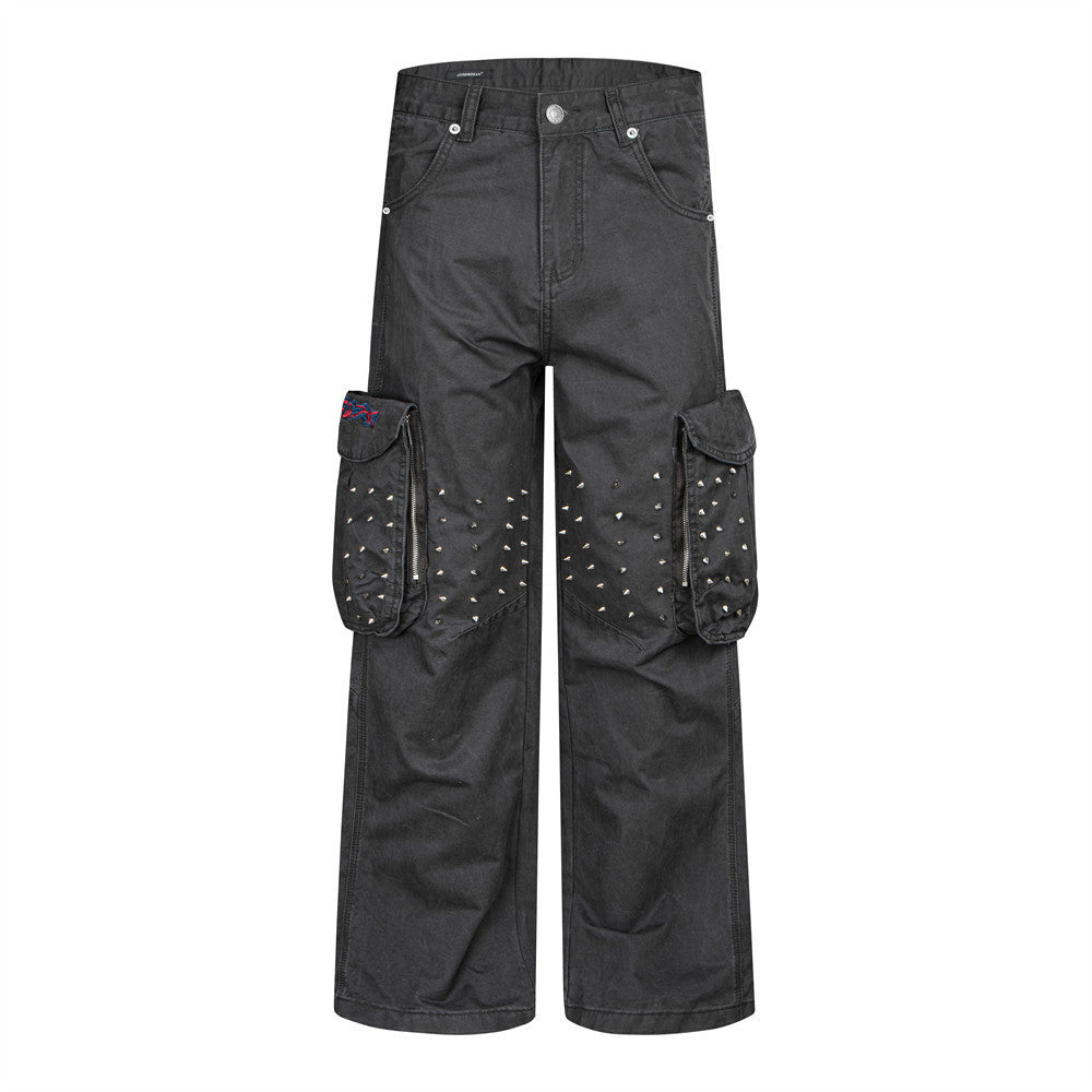 Dark grey wide-leg cargo pants with silver spike studs on large thigh cargo pockets, front and back view