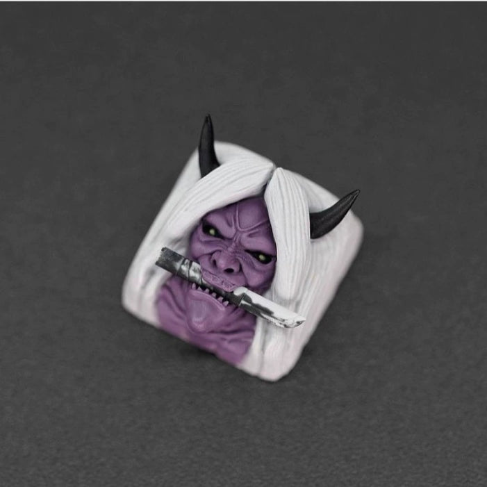 This premium quality Naruto Keycap features a purple demon face with long white hair and black horns, sword in its mouth, perfect for anime fans. Set against a dark background, its striking design resembles beloved characters from the Naruto Keycaps Set by Naruto.