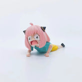 The Anya Forger Crying PVC Figure - 6cm from Spy × Family is a delightful collectible, showcasing the pink-haired character in a funny pose with a teal shirt and yellow shorts. Her cat-ear-like accessories add to its uniqueness and charm.