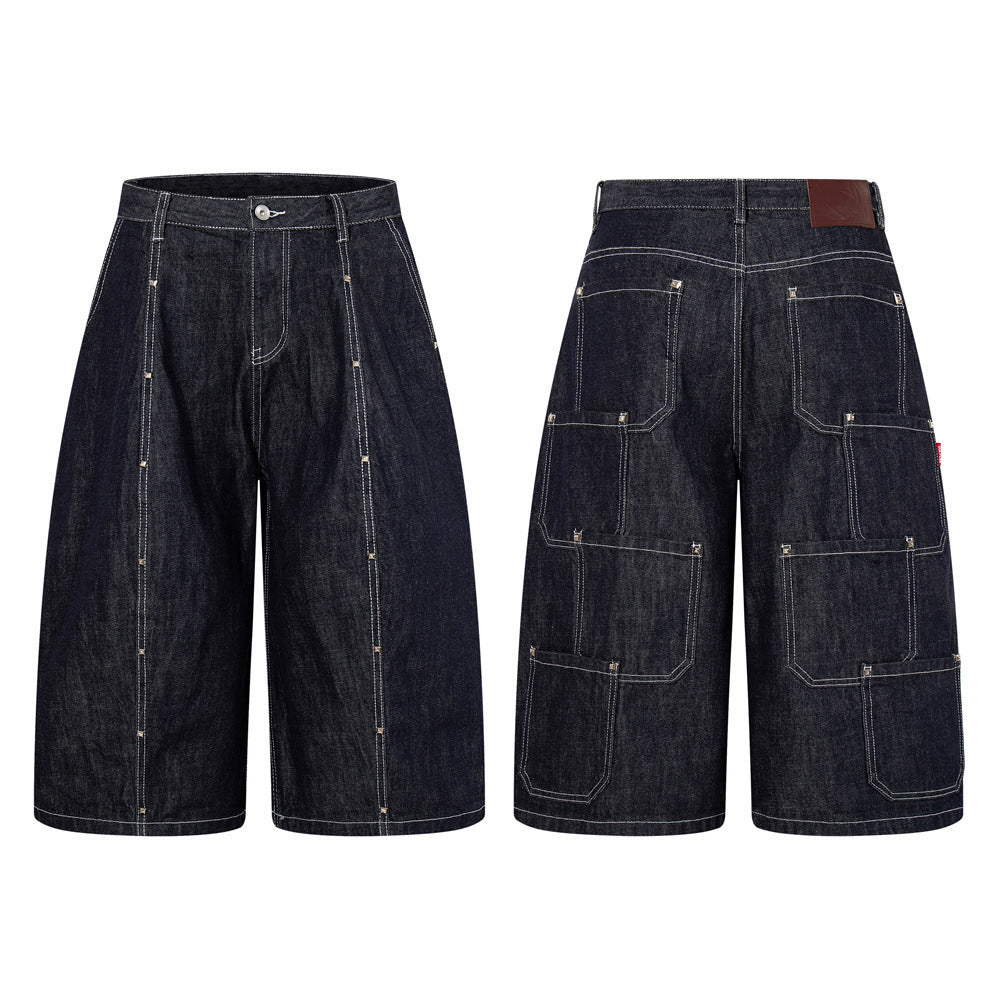 Dark indigo wide-leg denim cargo shorts with white contrast topstitching, rivet detailing, and multiple back utility pockets