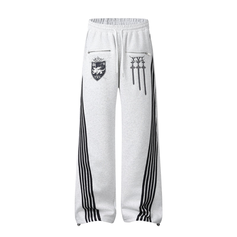 Pantalon de survêtement à jambes larges avec graphisme héraldique et détails latéraux multibandes