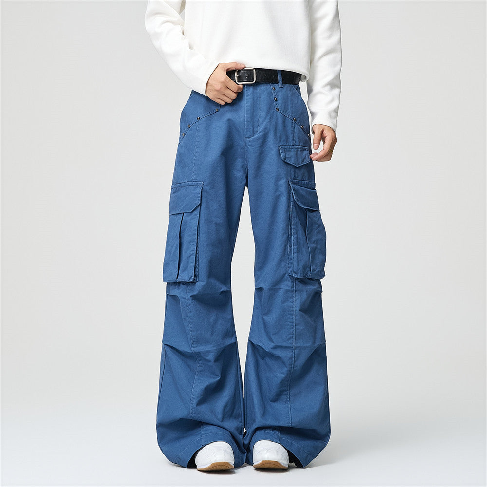 Men's wide-leg cargo pants in steel blue with multiple flap pockets and rivet waistband detail