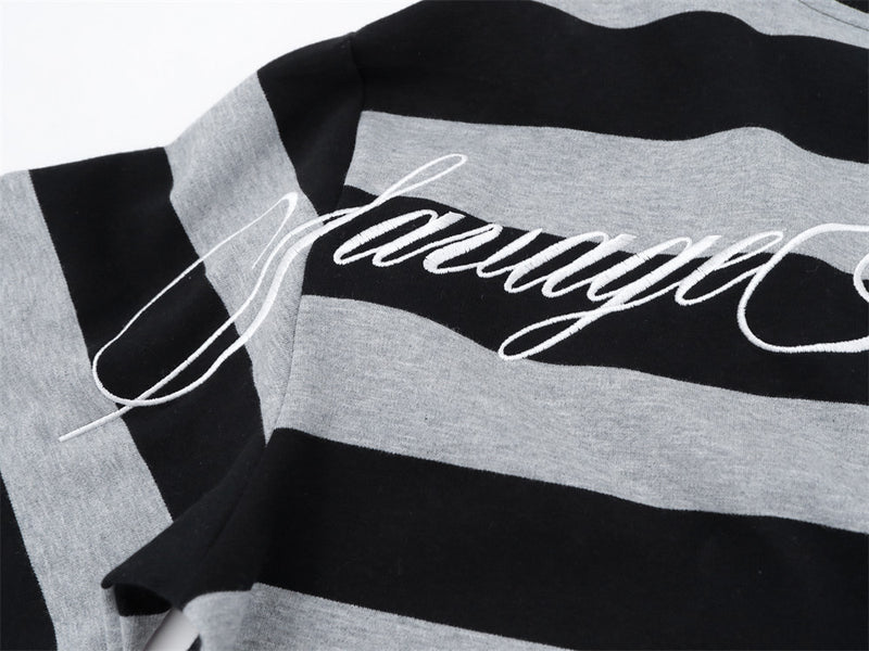 Close-up of oversized back graphic on black and gray striped long sleeve shirt