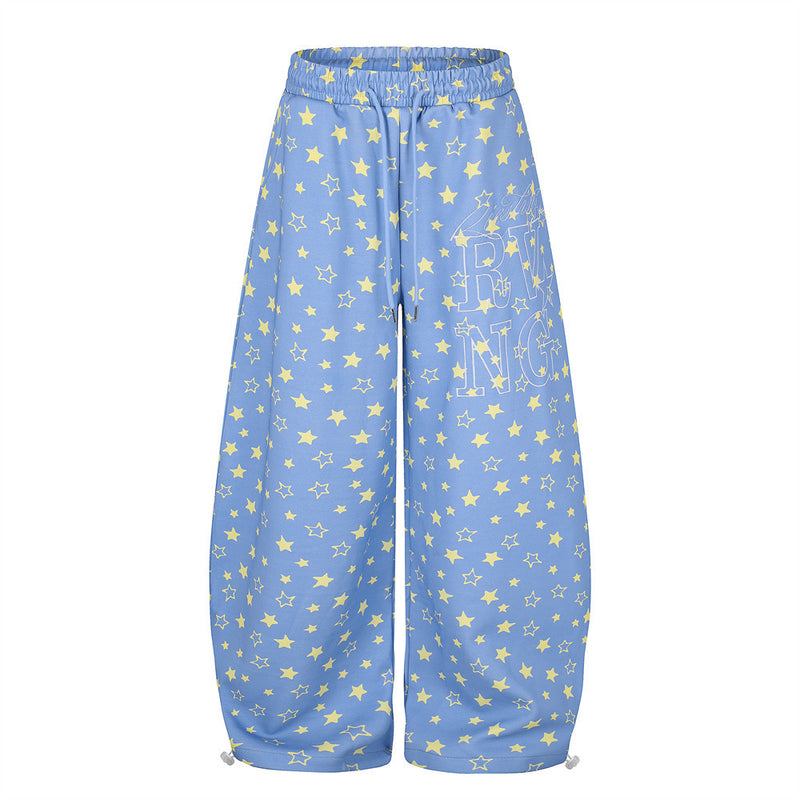 Oversized wide leg star print sweatpants in blue with yellow all-over star pattern and graphic logo print on right leg