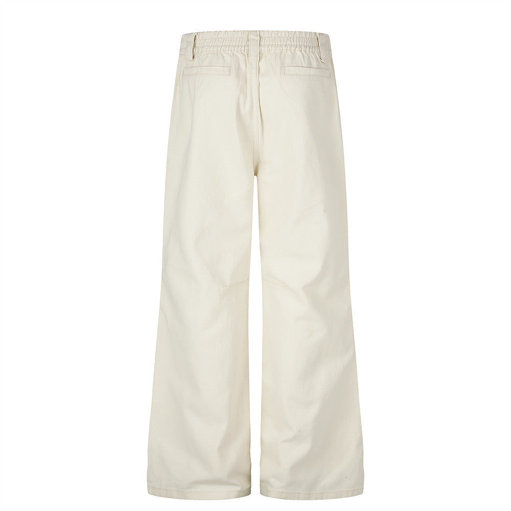 Pantalon homme coupe large orné de perles et de clous métalliques