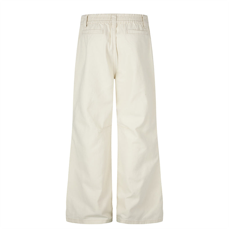 Pantalon homme coupe large orné de perles et de clous métalliques
