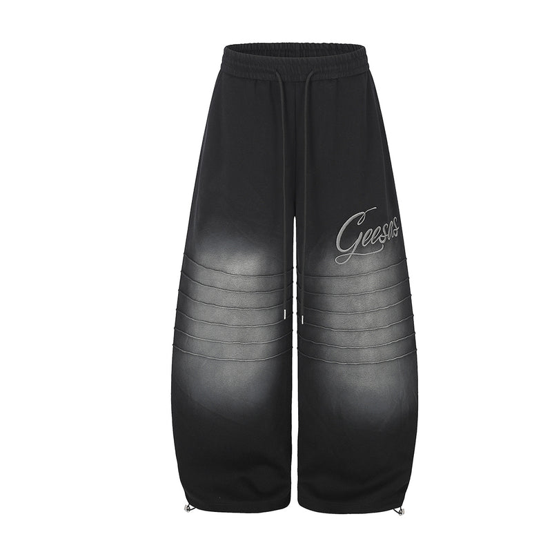 Pantalon de survêtement à jambes larges avec délavage dégradé et plis aux genoux