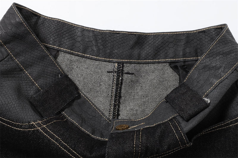 Inside waistband detail showing black denim jeans with belt loops and stitched lining