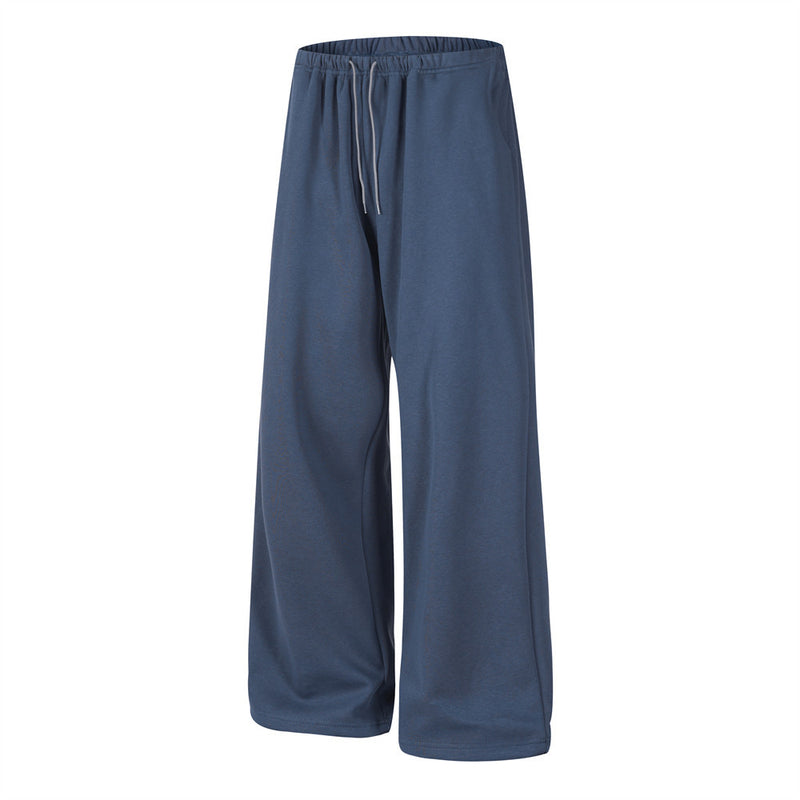 Front view of navy baggy track pants with elastic waistband and straight wide legs