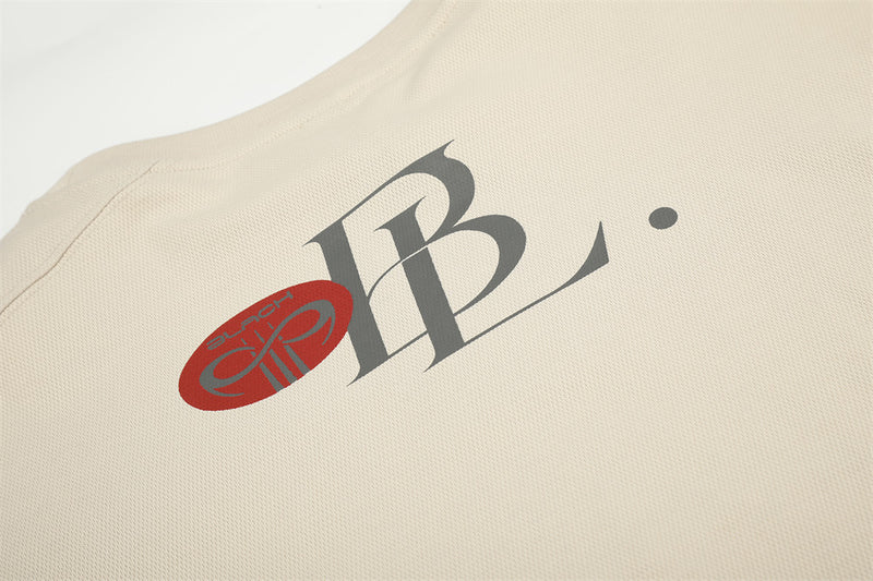 Beige tee upper back detail with script logo and neckline print