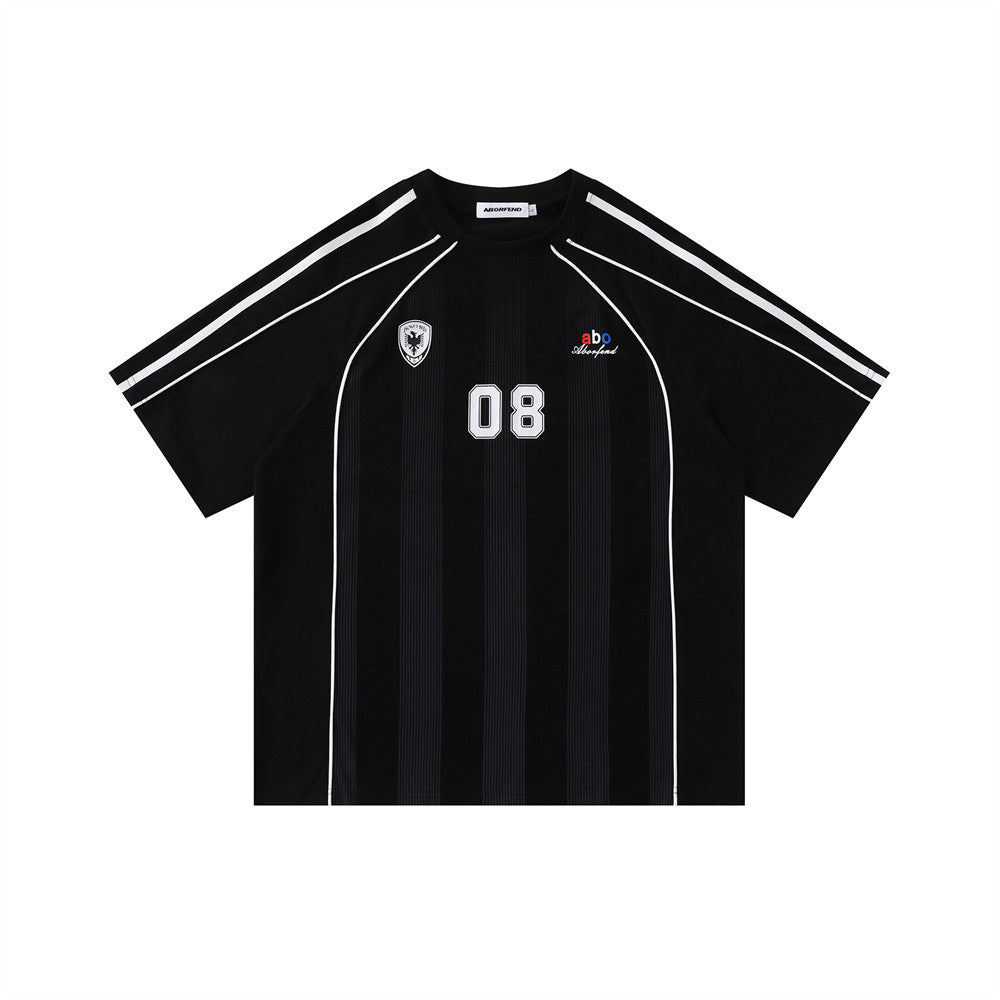 Oversized soccer jersey stripe graphic tee in black with embroidered crest and number 08 chest print, front view
