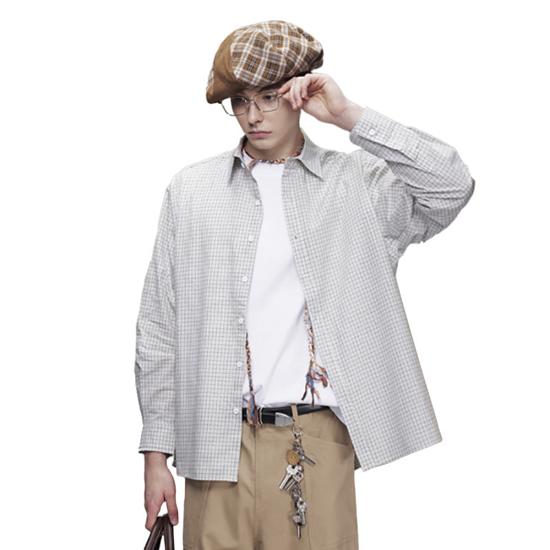 Men wearing an oversized boxy plaid long sleeve button-up shirt in black and white grid check with relaxed fit