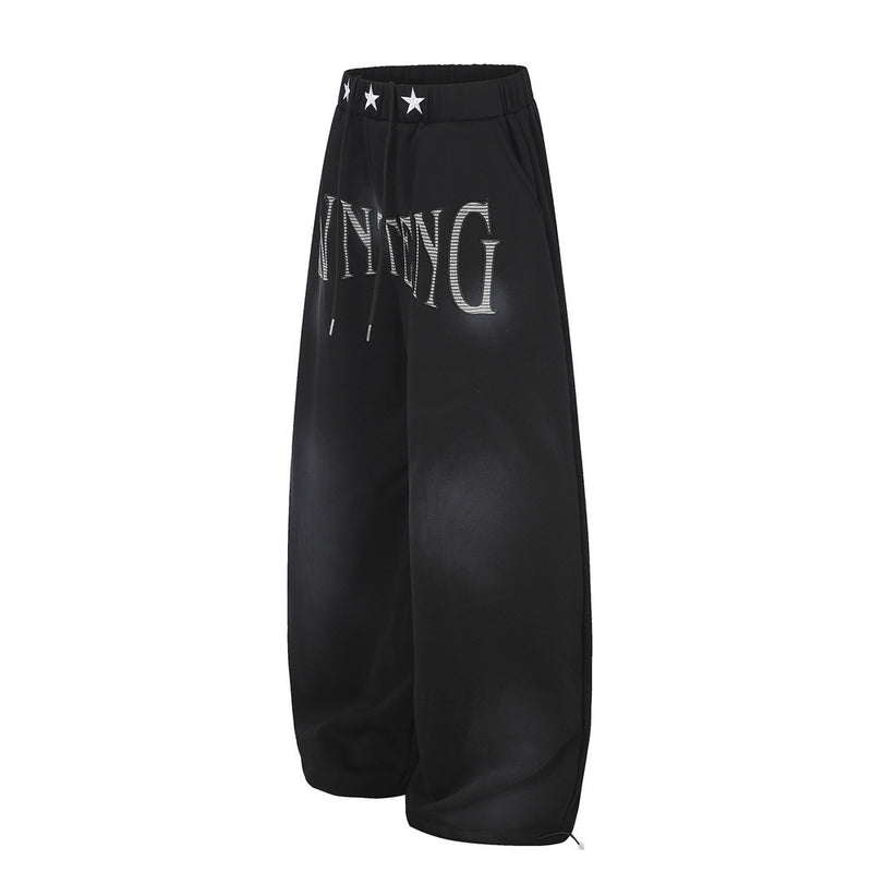 Pantalones de chándal holgados de pernera ancha con lavado efecto spray y gráfico de letras