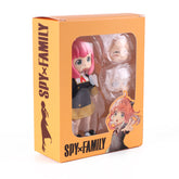 The Seakoff Anya & Yor Forger Nendoroid Set features poseable 13CM Spy x Family action figures. Anya sports her pink hair and dark outfit. The vibrant orange box, adorned with black lettering, includes an extra face piece and character illustrations—a must-have for collectors.