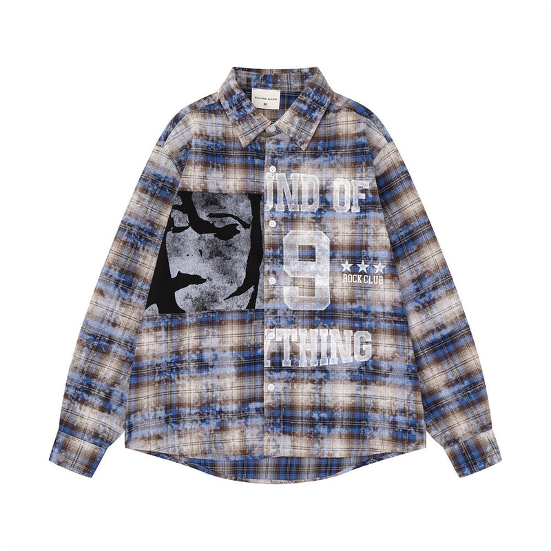 Front view of blue plaid long sleeve shirt with abstract face graphic and bold lettering