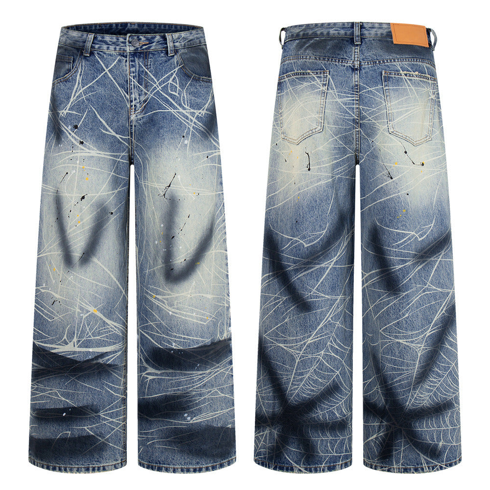 Baggy wide-leg jeans in faded blue denim with white scratch-line print and paint splatter, front and back view