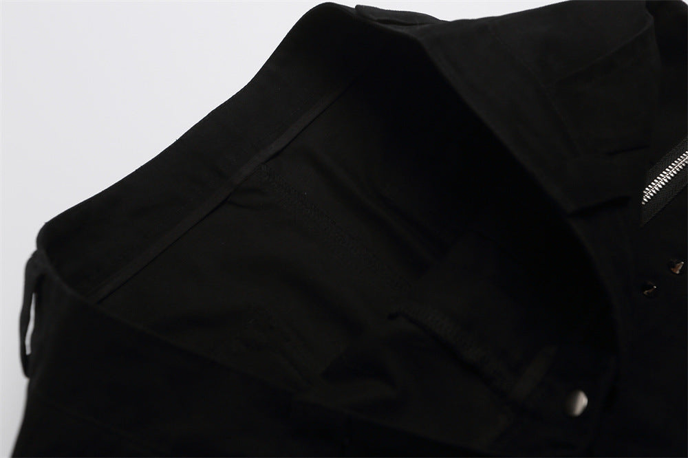 Close-up of black shorts waistband and side seam with zipper detail